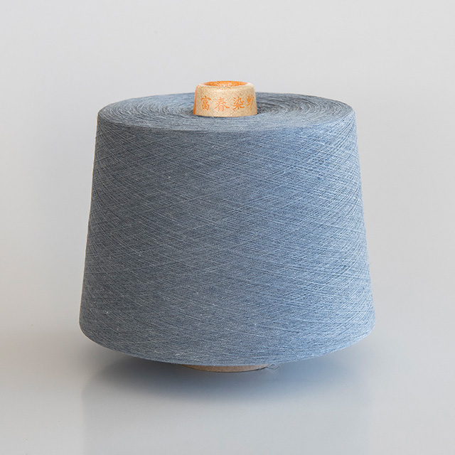 Melange yarn spools showing authentic heathered fiber texture